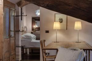 a dining room with a table and two lamps at Pent House Duplex in San Donato in Poggio