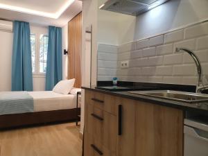 a kitchen with a sink and a bed in a room at El Nogal Home in Málaga