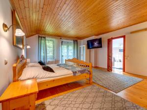 a bedroom with a bed and a wooden ceiling at Holiday Home Zameczek Falsztyn by Interhome in Falsztyn