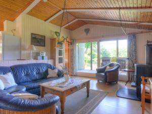 a living room with a blue couch and a table at Holiday Home Wiesenhütte by Interhome in Rott