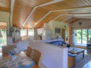 a kitchen and living room with a table and chairs at Holiday Home Wiesenhütte by Interhome in Rott
