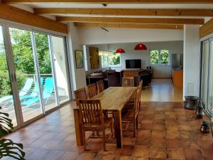 a kitchen and dining room with a wooden table and chairs at Villa Carinthia by Interhome in Köstenberg