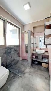 e bagno con servizi igienici, lavandino e doccia. di Υπόσκαφα cave concept ad Ammouliani