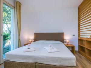 Posteľ alebo postele v izbe v ubytovaní Holiday Home Biovillage-6 by Interhome