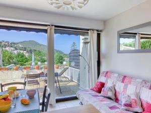 a living room with a couch and a table at Apartment La Madrague d'Azur-9 by Interhome in La Madrague