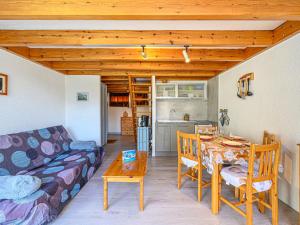 a living room with a couch and a table at Studio Phare de Kernevest-1 by Interhome in La Trinité-sur-Mer