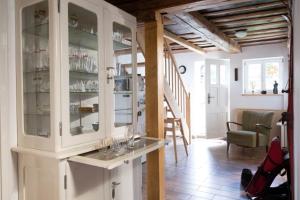 a kitchen with a white cabinet with glass doors at Ferienhaus "Am Bodeweg 1" in Schierke
