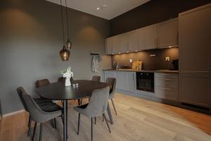 a kitchen with a dining room table and chairs at Elegant apartment in Trysil Alpine Lodge in Trysil