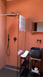 a bathroom with a shower and a black sink at CHALET in Milan +6 photos