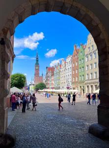 a group of people walking around a city street at Holiday Apartment Old Town Gdansk with a Jacuzzi in Gdańsk