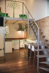 a loft apartment with a staircase and a dining room at Trigo Homes in Córdoba