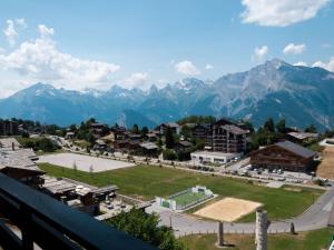 a view of a town with mountains in the background at Studio Christiania I R3 by Interhome in Nendaz