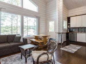 a living room with a couch and a table at Holiday Home Papulantupa by Interhome in Kulho