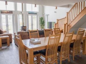 a dining room with a wooden table and chairs at Holiday Home One Mill Lands by Interhome in Uig