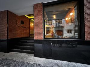 a brick building with a staircase and a window at Up Barrio Norte in Buenos Aires