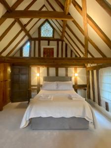 a bedroom with a large bed in a attic at The Tallow Factory in Dedham in Dedham