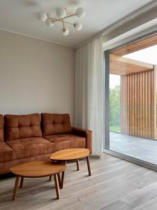 a living room with a couch and a table at Apartament Bosko przy Jeziorze Żywieckim Laguna Beskidów in Łodygowice