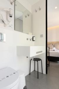 a bathroom with a sink and a toilet and a mirror at Hotel La Milagrosa in Alicante