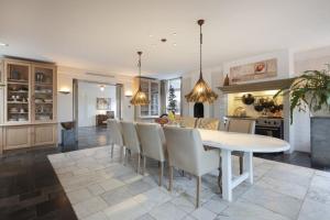 a kitchen and dining room with a white table and chairs at Amsterdam Mansion - Suite De Dam in Oostzaan