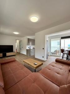 a living room with a large couch and a table at Harmony suites in Bol