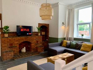 a living room with a couch and a fireplace at Stunning Rural Apartment - Sleeps 6 - Parking in Lichfield