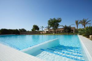 a large swimming pool with blue water at Cantó de Marina- Adults Only in Campos