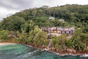 an aerial view of a house on a hill next to the ocean at Mango House Seychelles, LXR Hotels & Resorts in Baie Lazare Mahé