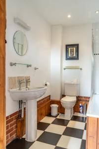 a bathroom with a sink and a toilet at The Dairy - Holly Tree Barns in Halesworth