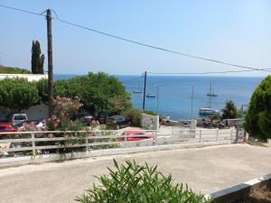 a white fence with a view of the ocean at Stafylos Rooms in Stafylos