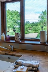 a kitchen counter with a window and a sink at The Stables - Holly Tree Barns in Halesworth