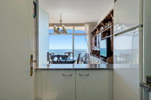 a kitchen with a view of the ocean from a room at Edificio Victoria 5º-7ª in La Playa