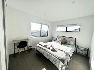 a bedroom with a bed with a dog laying on it at A&J Queen bedroom-Quiet and brand new with reserve view in Auckland
