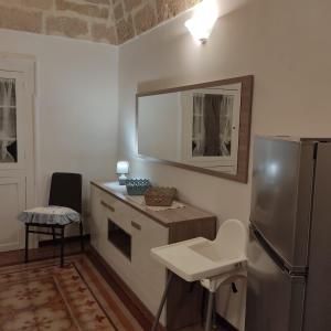 a kitchen with a refrigerator and a sink at DIMORA STORICA ALLA ROTONDA in Mottola