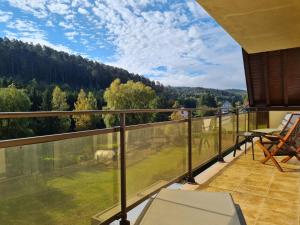 a balcony with a view of a field and trees at Hôtel Restaurant La Couronne by K in Reipertswiller