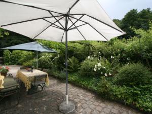a table and an umbrella in a garden at Holiday Home Vogelhütte by Interhome in Innsbruck