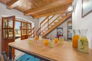 a wooden table with glasses of orange juice on it at Villa Laura - Orihi in Barban