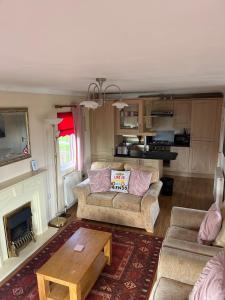 a living room with a couch and a coffee table at Wendy Lodge- Chalet Cottage in Padstow