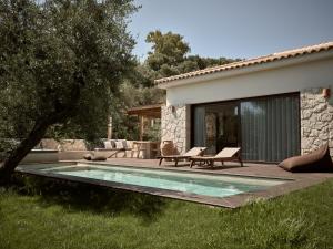 a backyard with a swimming pool and a house at Zayn Luxury Villas, a Serene Escape, By ThinkVilla in Zakynthos Town