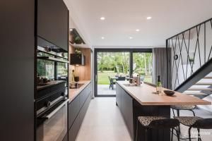 a kitchen with a counter and a dining room at Arbre Epine in Sart-lez-Spa