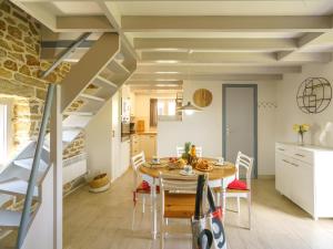 a kitchen and dining room with a table and a staircase at Holiday Home La petite Iroise by Interhome in Plogoff