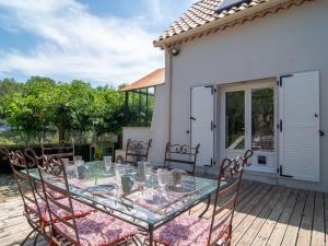 a glass table and chairs on a patio at Holiday Home Les Eaux Claires by Interhome in Salernes +28 photos