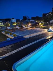 a pool in a parking lot at night at Vigor Horses in Połęcko