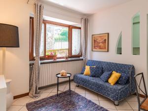 - un salon avec un canapé bleu et une fenêtre dans l'établissement Holiday Home Boni ferias by Interhome, à Colico