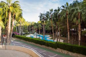a resort with a swimming pool and palm trees at Samaniego ID175 in Orihuela Costa