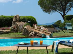 a pool with a table with drinks on it at Villa La Veduta by Interhome in Grosseto +42 photos