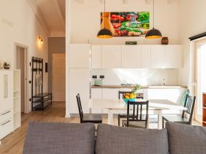 Una sala de estar con un sofá y una mesa con sillas. en Apartment Casa La Villa by Interhome, en Verceia