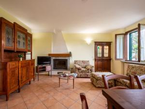 a living room with a couch and a fireplace at Holiday Home Vallegra by Interhome in Cortiglione