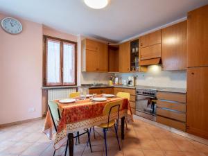 a kitchen with a table with chairs and a clock at Holiday Home Vallegra by Interhome in Cortiglione