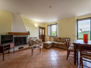a living room with a couch and a fireplace at Holiday Home Vallegra by Interhome in Cortiglione