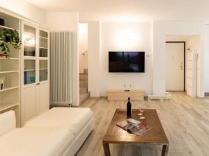 a living room with a white couch and a table at Holiday Home Luxury House by Interhome in Colico
